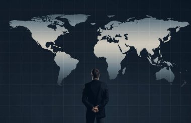 Businessman standing over world map background. Business, globalization, concept clipart
