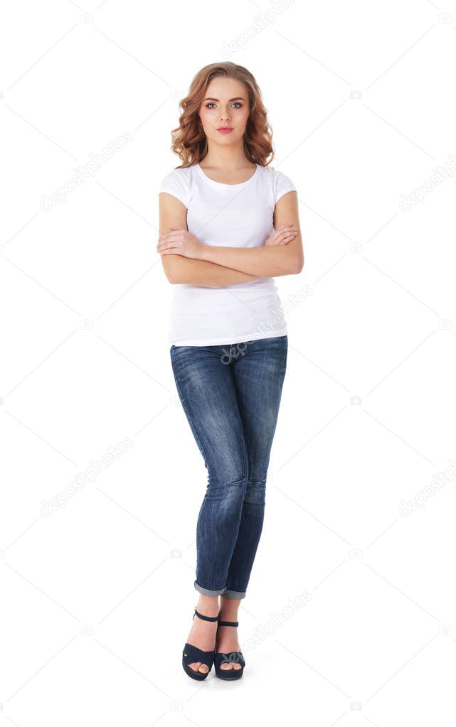 Young and beautiful teenage girl in denim jeans isolated on white