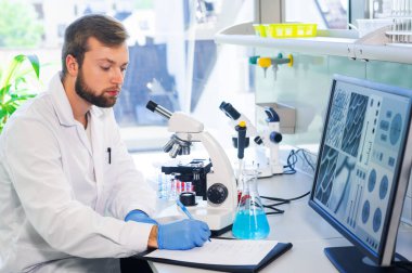 Scientist working in lab. Doctor making microbiology research. Laboratory tools: microscope, test tubes, equipment. Biotechnology, chemistry, bacteriology, virology, dna and health care concept. clipart
