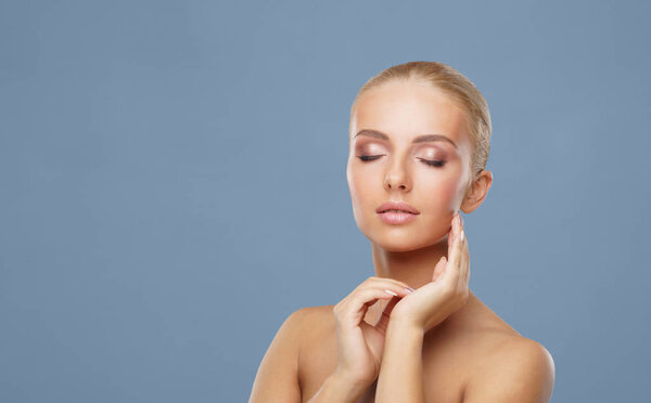 Attractive face of beautiful girl. Close-up portrait of healthy woman. Skin care, cosmetics, makeup, complexion and face lifting concept.