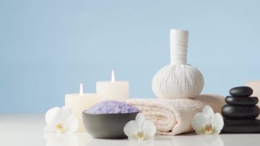 Oryantal masaj tedavisi kompozisyonu. Havlu, mumlar, çiçekler, taşlar ve bitkisel toplar. Spa prosedürleri, meditasyon, refah ve aromaterapi kavramı.