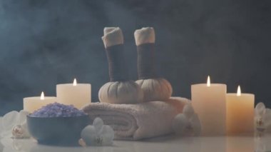 Oryantal masaj tedavisi kompozisyonu. Havlu, mumlar, çiçekler, taşlar ve bitkisel toplar. Spa prosedürleri, meditasyon, refah ve aromaterapi kavramı.