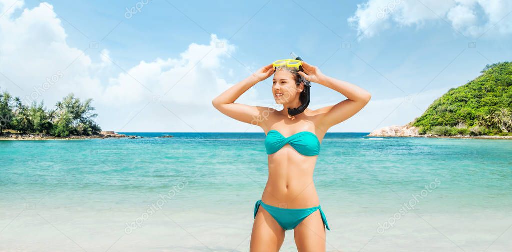 Young and beautiful woman in swimsuit relaxing on the beach. Girl having summer vacation in Thailand. Holidays and traveling concept.