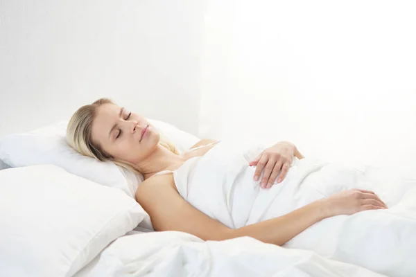 침대에 아름다운 금발의 잠자는 침실에서의 창문에서의 건강과 — 스톡 사진