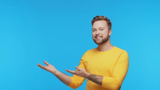 Expressive Young Man Vibrant Background Studio Portrait Handsome Person Pointing — 비디오