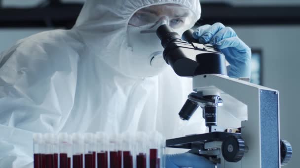 Tudós Védőruhában Maszkban Kutató Laborban Dolgozik Laboratóriumi Felszereléssel Mikroszkópok Kémcsövek — Stock videók
