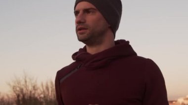 Genç adam dışarıda akşam eğitimi alıyor. Şehir günbatımı geçmişi. Spor, spor ve spor konsepti.