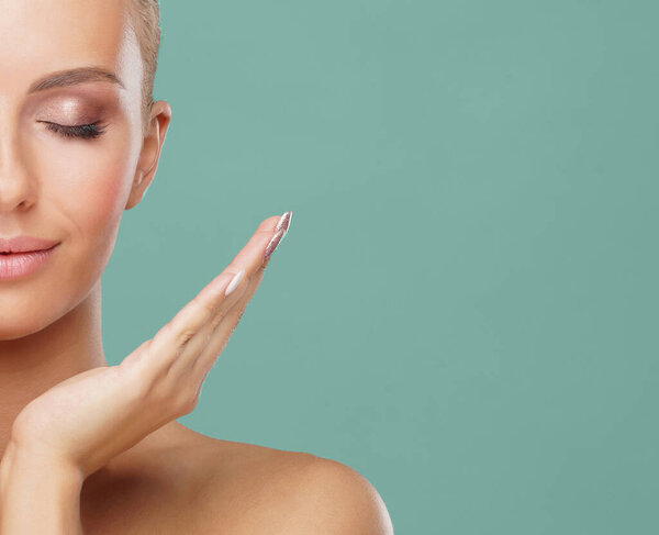 Attractive face of beautiful girl. Close-up portrait of healthy woman. Skin care, cosmetics, makeup, complexion and face lifting concept.