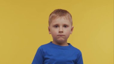 Tişörtlü mutlu gülümseyen çocuğun portresi. Stüdyodaki etkileyici çocuk. Çocukluk kavramı.