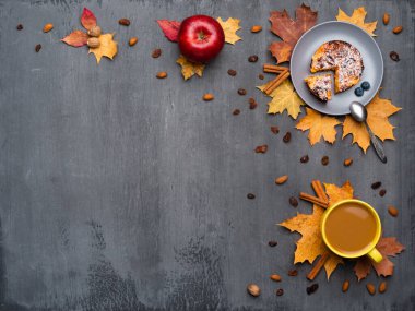 Mevsimlik sonbahar geçmişi. Renkli akçaağaç yaprakları ve bir fincan sıcak içecek, kahve, latte veya kapuçino, hindistan cevizi, kek, elma ve tarçın..