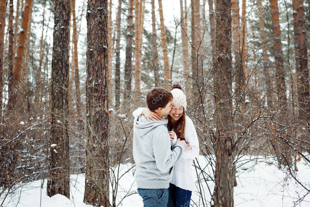 Loving couple in winter forest
