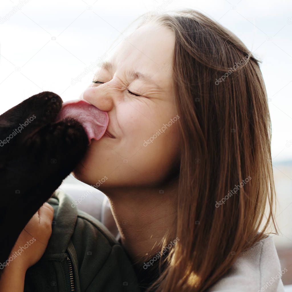 Dog licking face of  woman