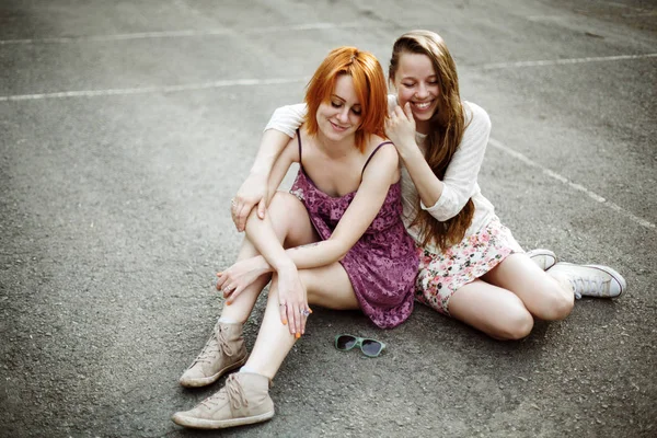 Two teen girls sitting on the playground — Stock Photo, Image