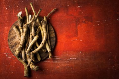 Horseradish root on red vintage background clipart