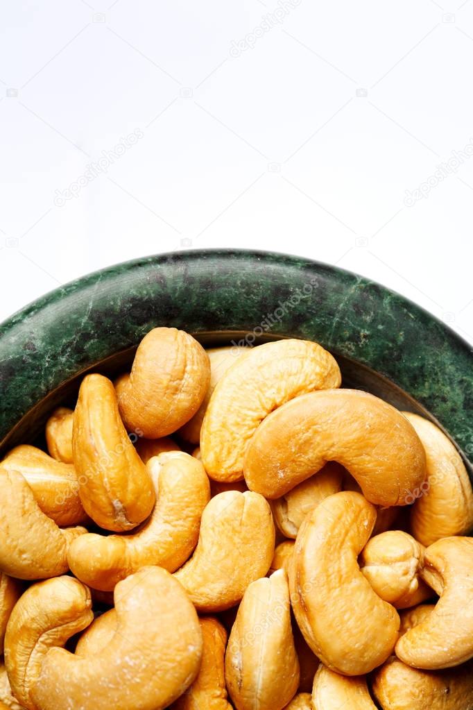 Roasted cashew nuts in a marble bowl 