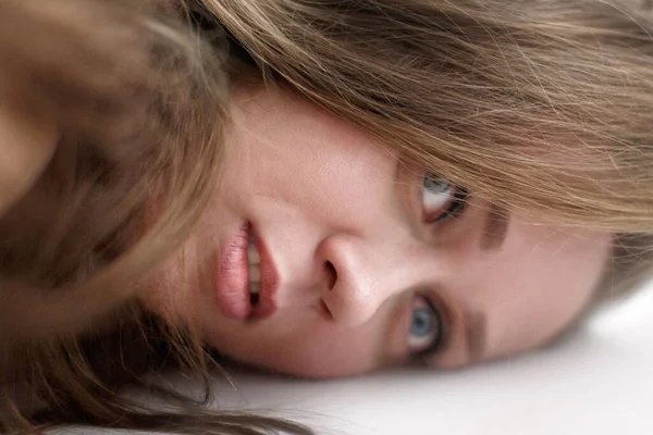 Woman crisis conceptual portrait. Close-up of lying woman with long hair and melancholy face, selective focus — Stock Photo, Image