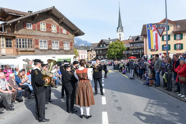 People wearing traditional clothes and playing music