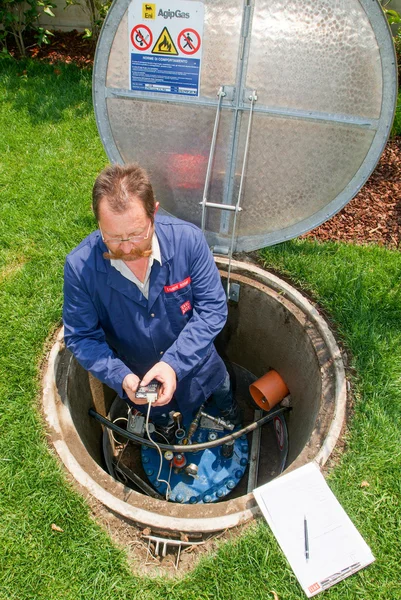 Technician making maintenance at a Gas tank on the garden — Stock Photo, Image