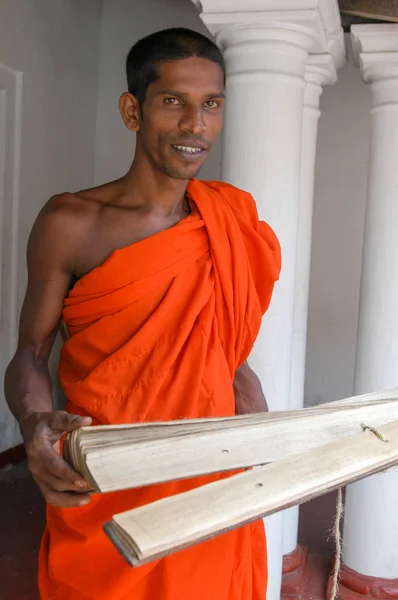 Buddhist priest with holy scriptures — Stock Photo, Image