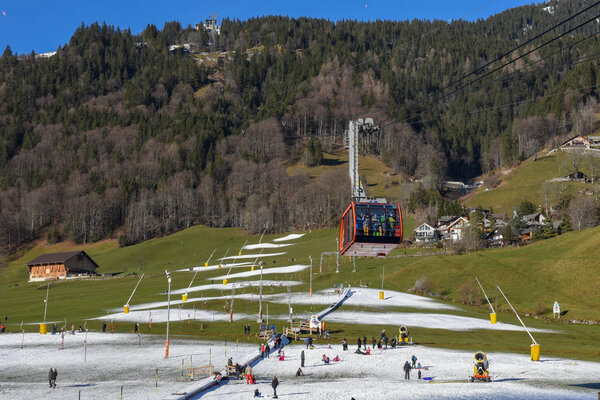 Engelberg, Switzerland - 29 December 2019: ski lift with artificial snow manufactured by snow cannons at Engelberg on the Swiss alps