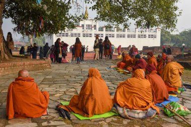 Lumbini, Nepal - 18 January 2020: monks praying at Maya Devi temple birth place of Buddha in Lumbini on Nepal