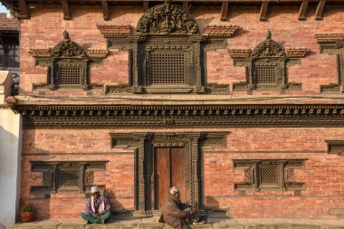 Bhaktapur, Nepal - 27 Ocak 2020: Nepal 'de Bhaktapur' da Durban Meydanı 'nda bir tapınakta oturan insanlar