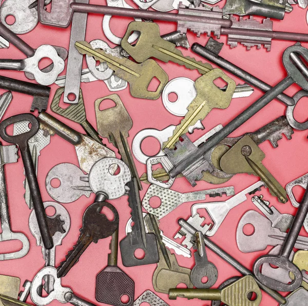 Keys set on pink background. Door lock keys and safes for proper