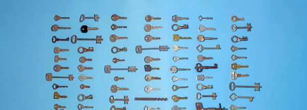 Keys set on blue background. Door lock keys and safes for property security and house protection. Different antique and new types of keys. — Stock Photo, Image