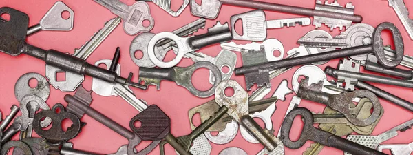 Keys set on pink background. Door lock keys and safes for proper