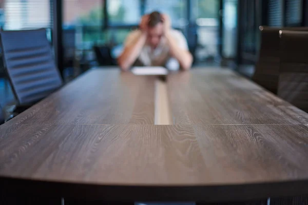 Fired employee in conference room. Manager at table in modern meeting room for business negotiations and business meetings.