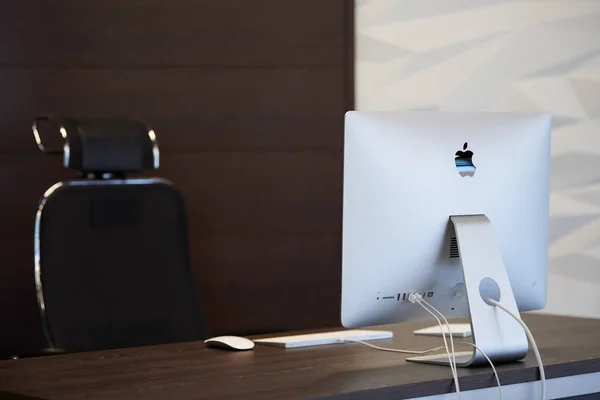 Modern workplace with Apple iMac computer. Office work place for designer. Minimal desktop area for productive work. Dismissal concept - 2019.07.07 - Russia, Nizhny Novgorod.