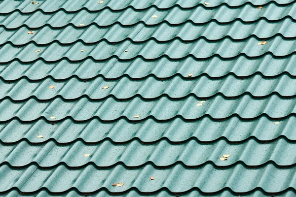 Modern green roof tile pattern. Reliable house rooftop cover against bad weather.