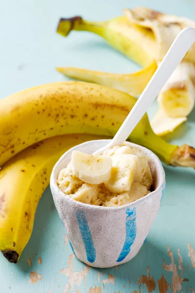 Frozen banana in ceramic cup.