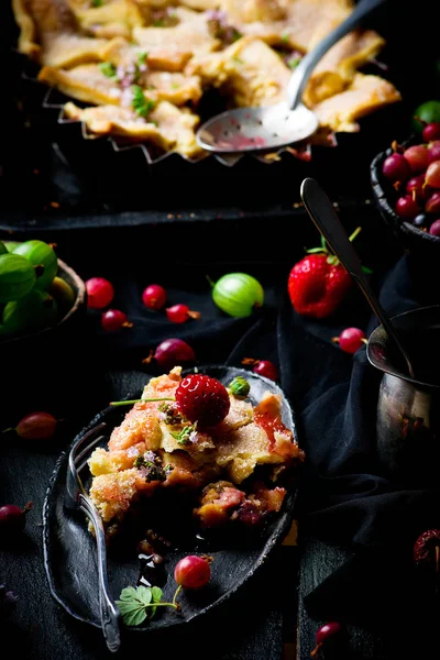 Patchwork  strawberry and gooseberry pie. dark photo — Stock Photo, Image