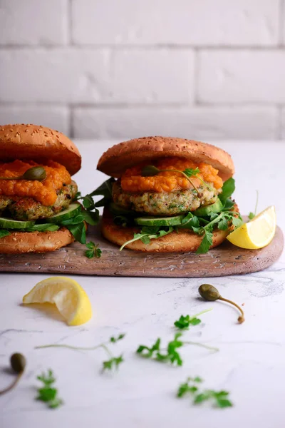 Fish burger with herb and corgette sauce. — Stock Photo, Image