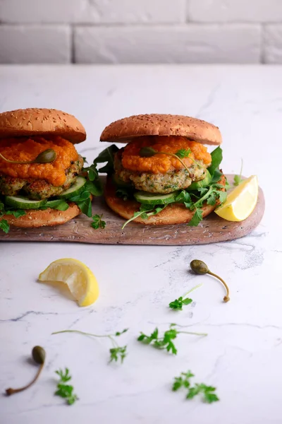 Fish burger with herb and corgette sauce. — Stock Photo, Image