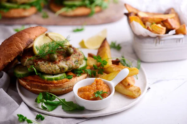 Fish burger with herb and corgette sauce. — Stock Photo, Image