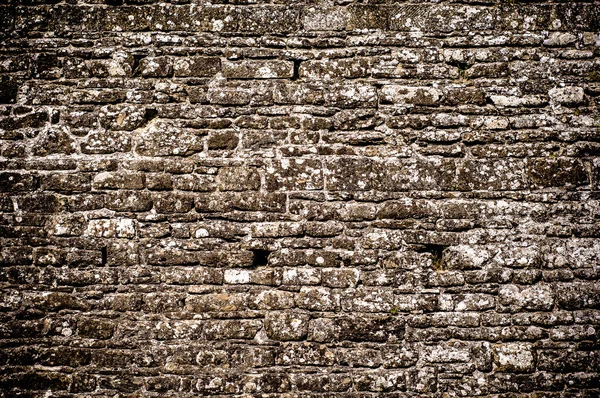 Stenen muur textuur achtergrond. Rechtenvrije Stockafbeeldingen
