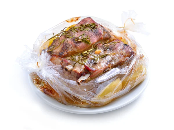 Baked meat packaged in a sleeve for baking. Pork belly with gree — Stock Photo, Image