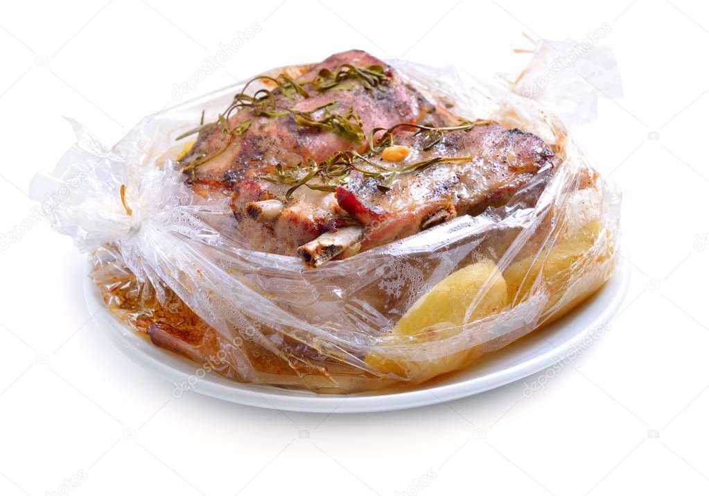 Baked meat packaged in a sleeve for baking. Pork belly with gree