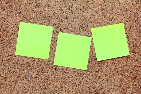 Yellow sticky notes on a cork board — Stock Photo, Image