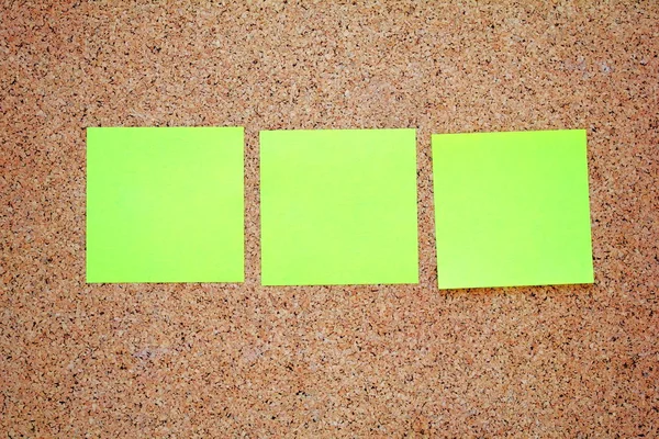 Yellow sticky notes on a cork board — Stock Photo, Image