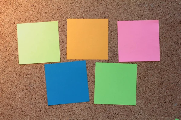 Colorful sticky notes on a cork board — Stock Photo, Image