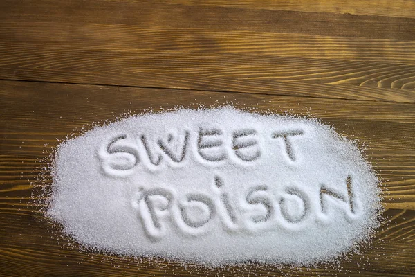 SWEET POISON written on pile of sugar