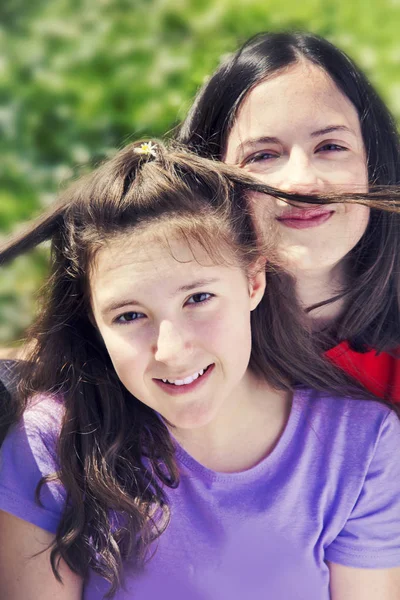 Pretty teenage girls playing with hear — Stock Photo, Image