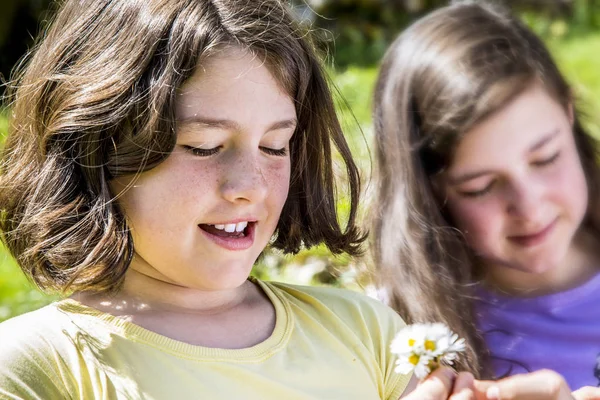 Красивые девочки-подростки играют с цветами — стоковое фото