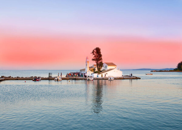 Vlacheraina Orthodox monastery during the evening, people enjoy sunset on the island of Corfu, Greece.
