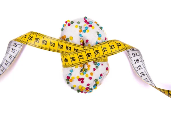 Doughnut tied measuring tape on white background. Diet concept. — Stock Photo, Image
