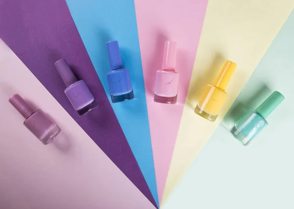 Multi-colored nail polishes on a colorful background — Stock Photo, Image