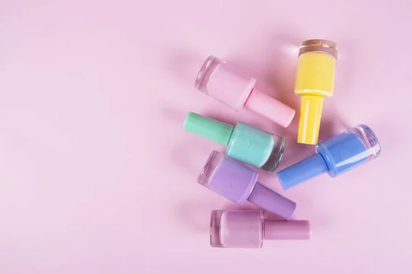 Multi-colored nail polishes on a colorful background — Stock Photo, Image